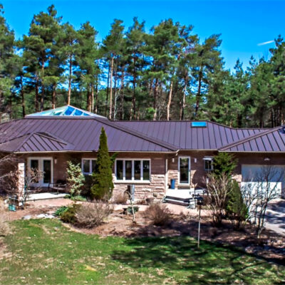 Standing seam roofing in brown on a residence, one of Alrpo Metal Roofing projects.