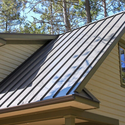 Standing seam roofing on a home in the woods.