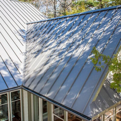 Standing seam roofing on a home in the woods.