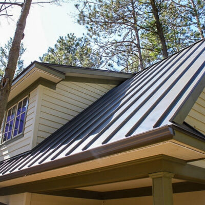 Standing seam roofing on a home in the woods with close up on soffits.