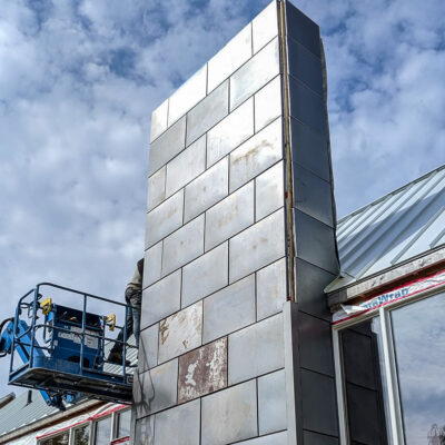 22g Corten on a 23' tall chimney wall before the natural rusting process.