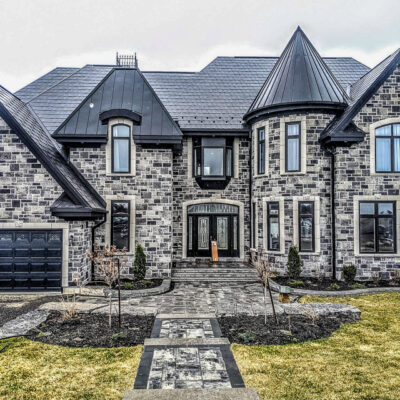 Standing metal and metal shingles on a castle build home, one of Alpro Metal Roofing projects.