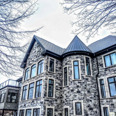 Standing metal and metal shingles on a castle build home, one of Alpro Metal Roofing projects.