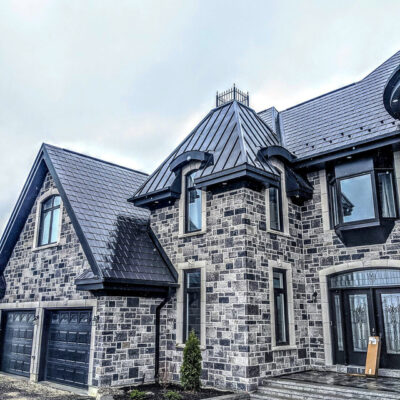 Standing metal and metal shingles on a castle build home, one of Alpro Metal Roofing projects.